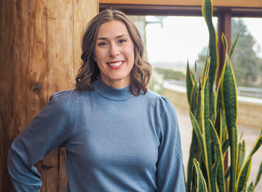 Photo of Christine Nessler, a female MFA graduate, in front of a window