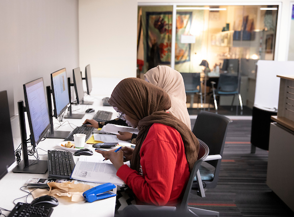 student working on a laptop at UNO