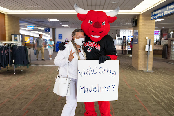 Madeline Adams at the Omaha airport with Durango, ready to walk the stage to receive her online degree.