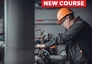 Factory worker in hard hat at machine