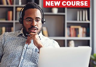 Man with earphone headset working on laptop in home office