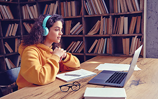 female student sitting at laptop
