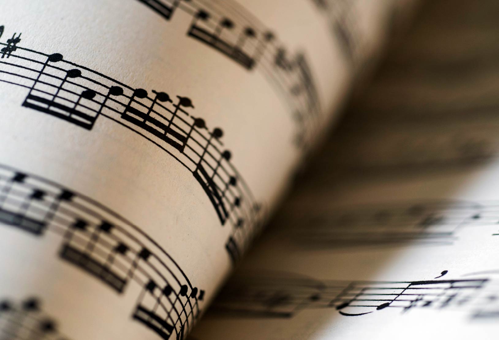 Close-up of sheet music with musical notes printed on the page.
