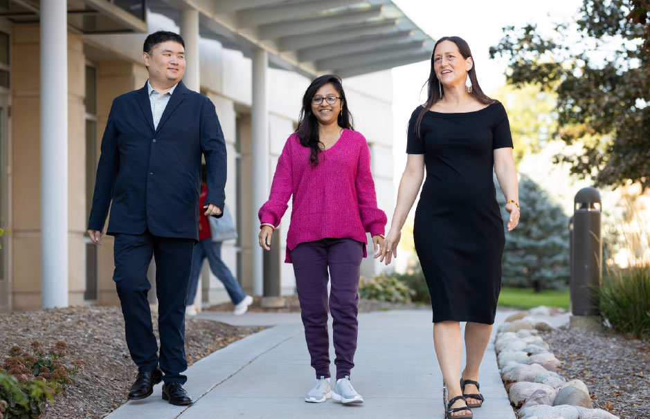 Three professionals walk together on campus, symbolizing the strength of the UNO MPA professional network and community engagement.