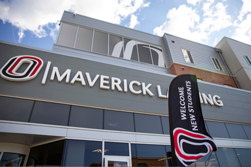 Maverick Landing building with "Welcome New Students" banner outside