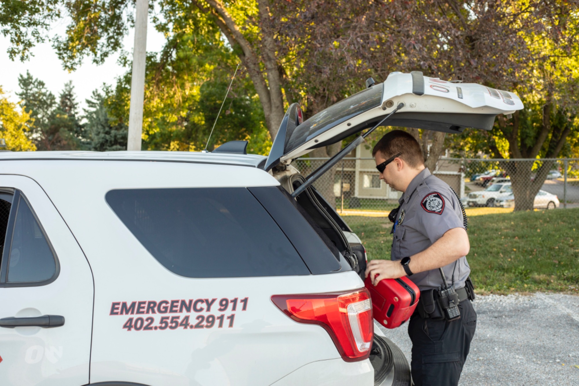 Campus security officer getting supplies from the back of their security vehicle