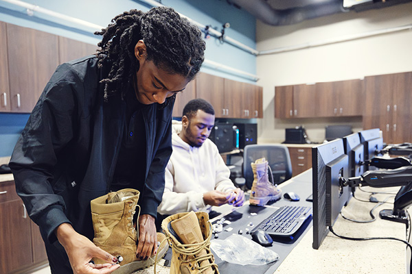 student works with footwear prototypes in a campus biomechanics lab.