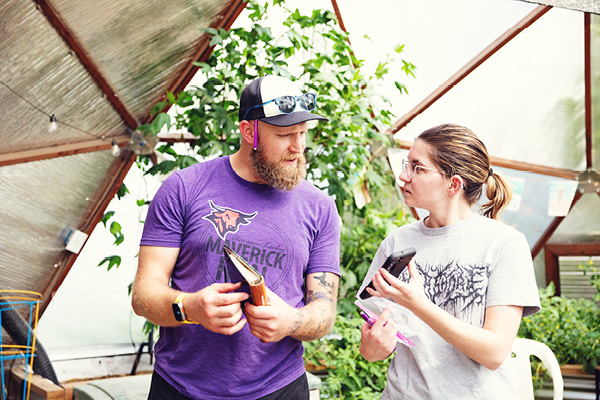 A group of students collaborates on a project using computers in a classroom.
