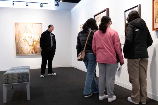 Four high school students view Samuel Bak's art in the Bak Gallery