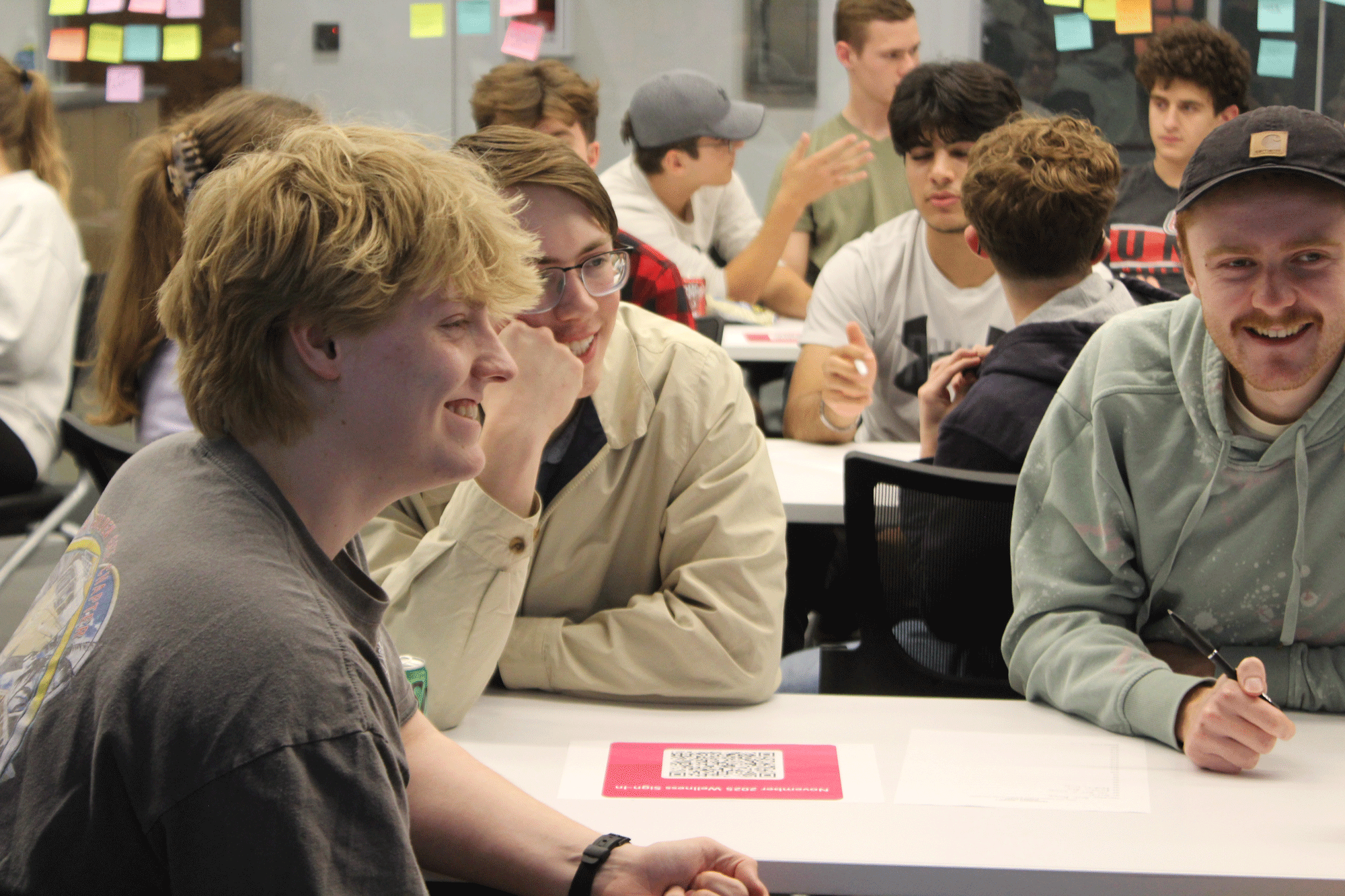 Three male students at trivia night wellness event