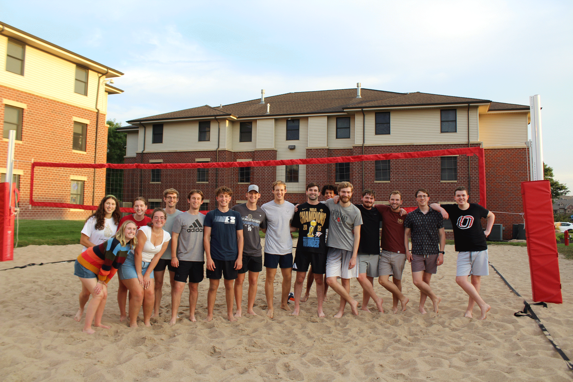 Large group of Scott Scholars playing sand volleyball.