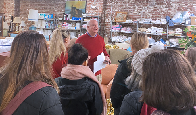 Craig Howell, executive director of Together, gives a tour of the organization’s pantry to UNO students as part of their SNAP Awareness project.