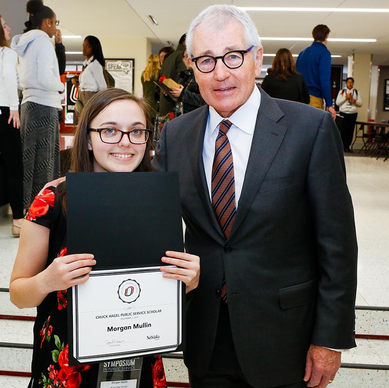 chuck hagel stands with a female student.