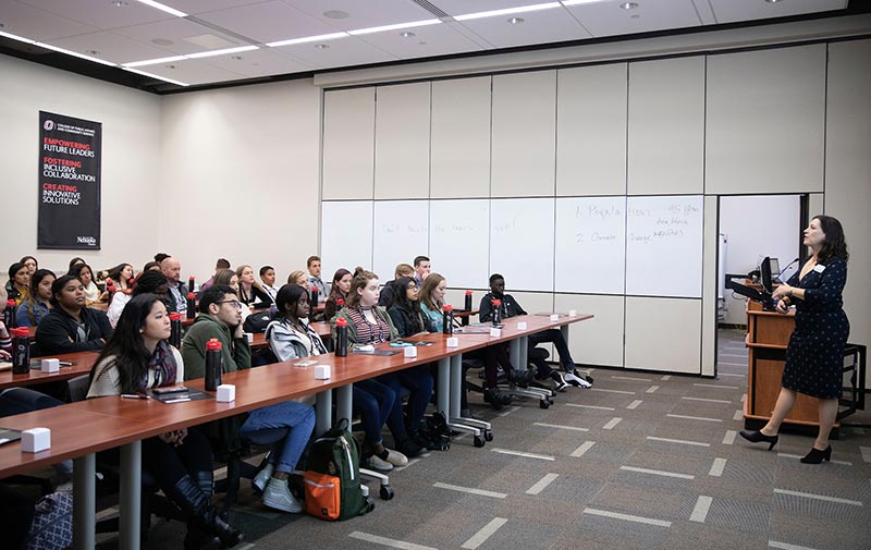 a room full of students sitting at tables.