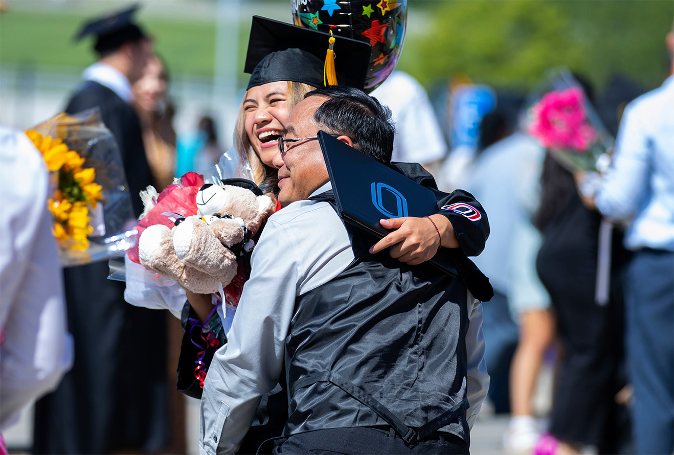 Students are congratulated by their families after graduation. 