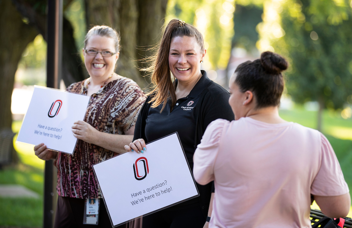 Members of the Staff Advisory Council, including Melissa Eckstein, left, and Rachael Jensen, answer questions for passing students, faculty and staff outside the Eppley Administration Building at the University of Nebraska at Omaha in Omaha, Nebraska, Thursday, August 29, 2019. SAC members were stationed around campus, available to answer questions during the first week of classes.
