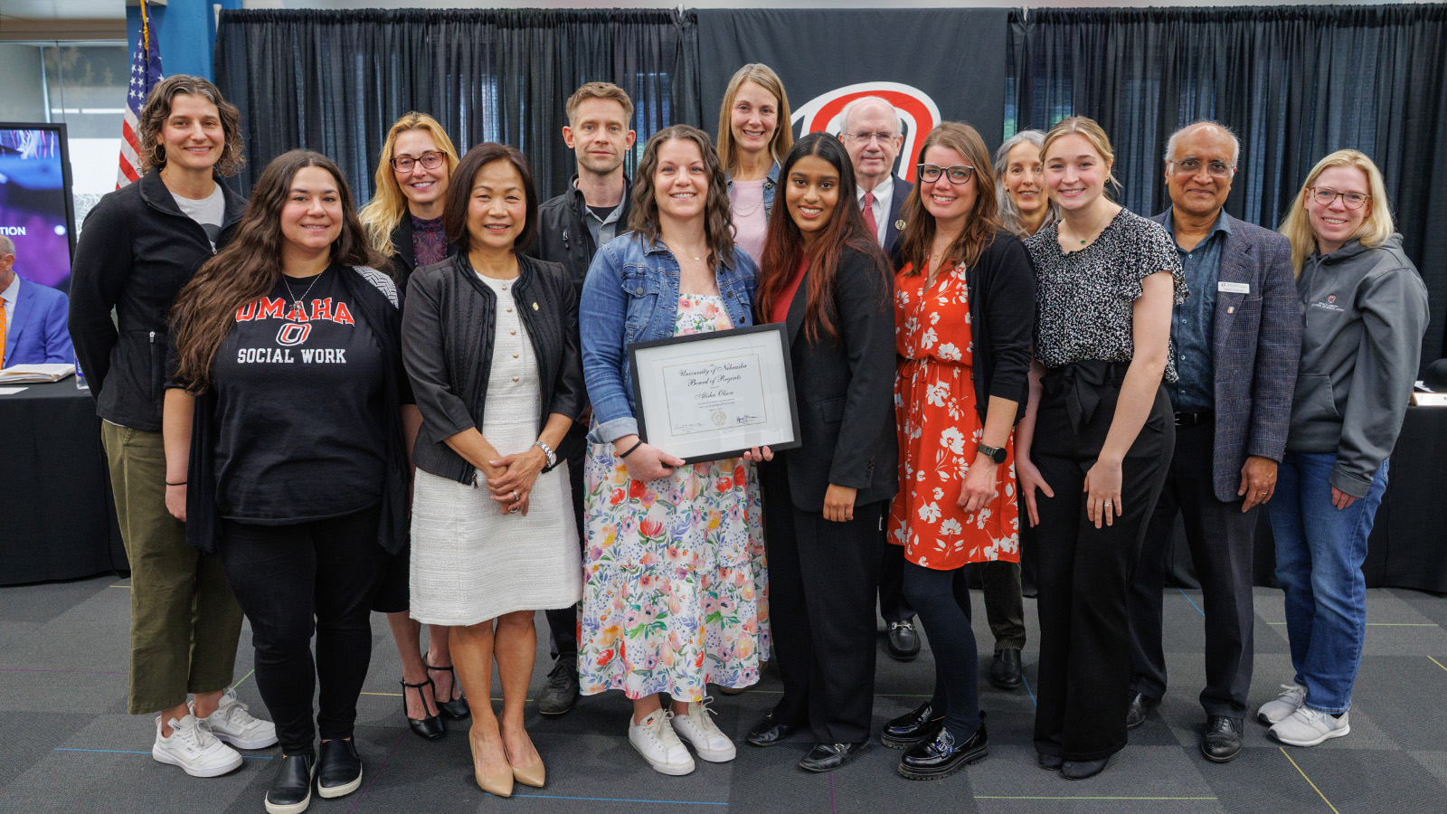 Pictured: (Back row) Ellen Rice, Assistant Director; Dr. Susan Reay, Director of the Grace Abbott School of Social Work; Justin Olson, recipient's husband; Kersten Borer, Instructor; President Gold; Konnie Kirchner, Field Practicum Coordinator; Dr. Henry D'Souza, Graduate Program Chair; Michelle Manning, Field Practicum Specialist; (Front row) Theori Kenny, Field Practicum Specialist; Chancellor Li; Alisha Olson, recipient; Regent Adidam; Katie Robbins, Senior Outreach Coordinator and Meghan Witte, Graduate Assistant.