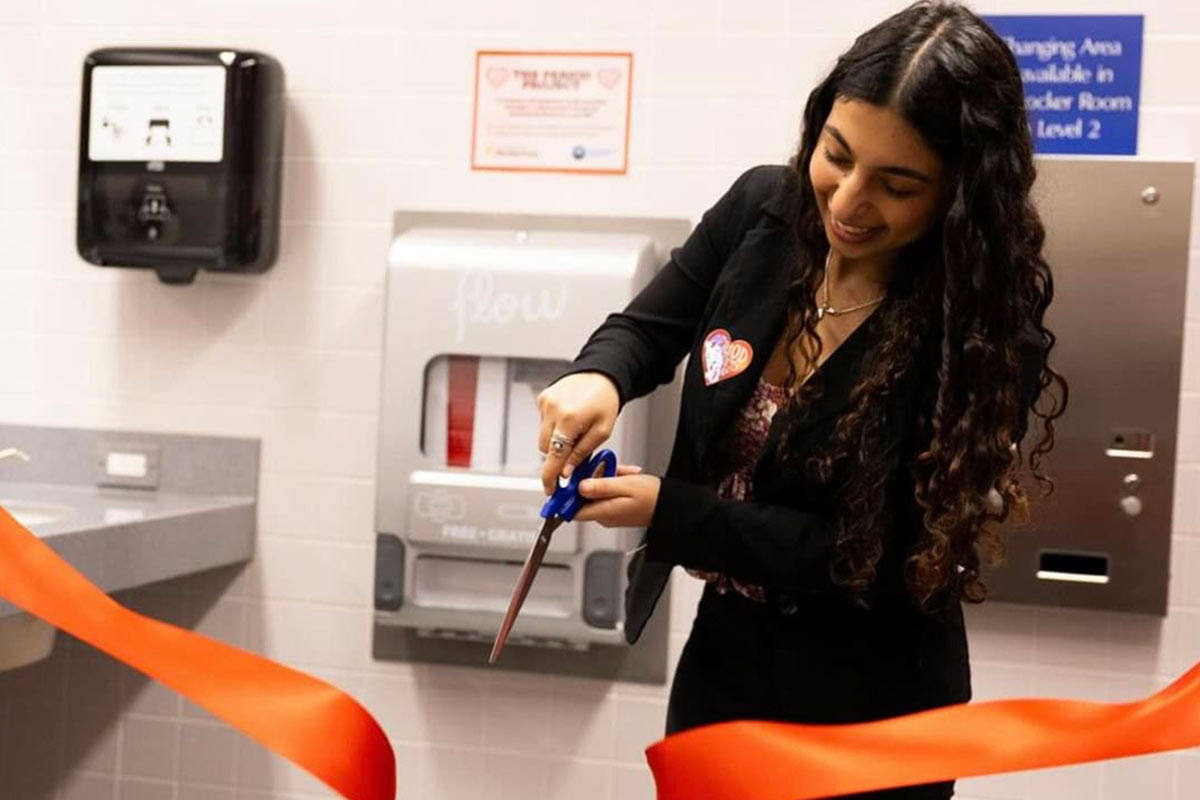 Photo from the Aunt Flow website shows woman cutting ribbon at opening of display.