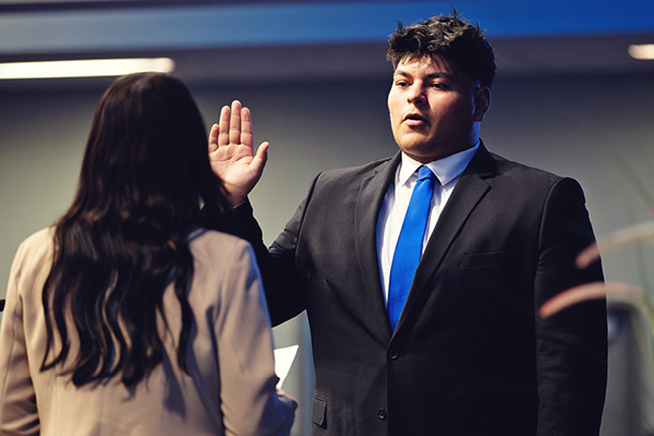 A student speaks at a podium during a student government event.