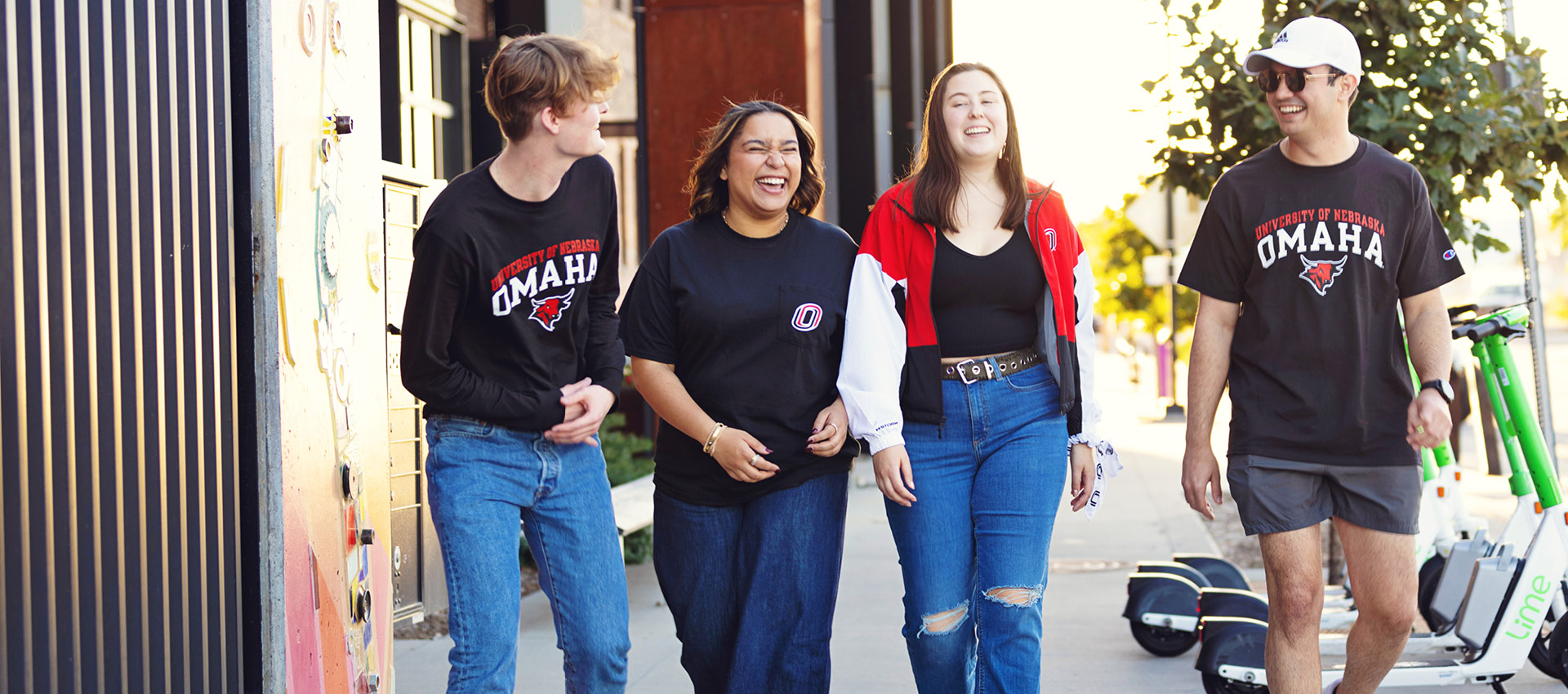 Students walking together on campus, laughing and talking.