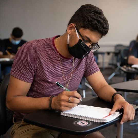 UNO student in class wearing a mask.