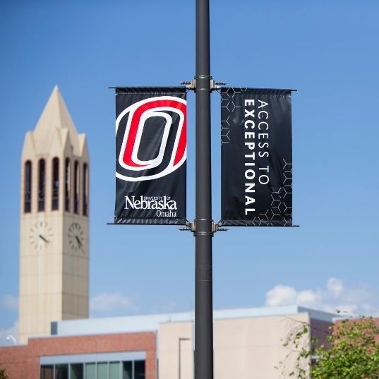UNO campus flag printed with, "Access to Exceptional".