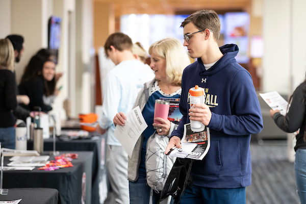 UNO students ask questions at an event.