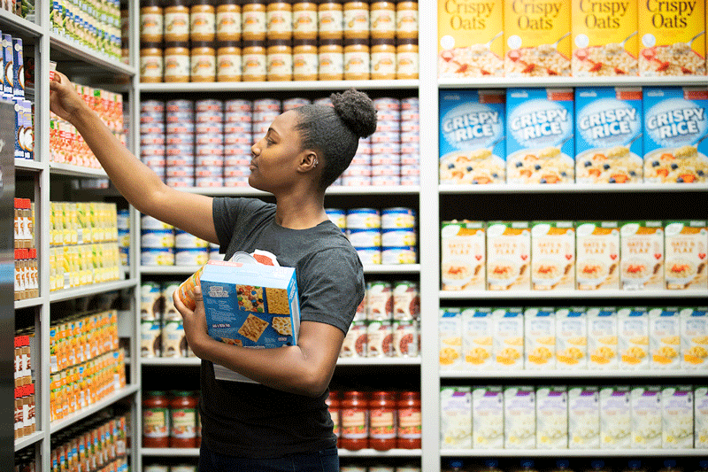 Maverick Food Pantry student worker stocks shelves