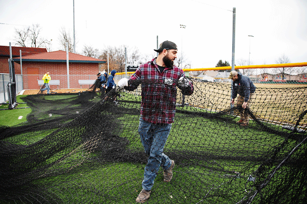 Volunteers work at Christie Heights Park, home of Police Athletic Community Engagement (PACE) baseball, as part of the University of Nebraska at Omaha's Alumni Global Day of Service to conclude Seven Days of Service in Omaha, Nebraska, Saturday, March 23, 2019.