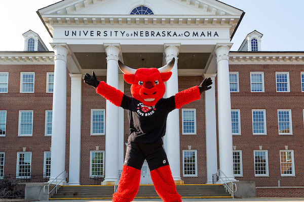 uno's mascot durango standing in fron of the iconic arts and sciences hall