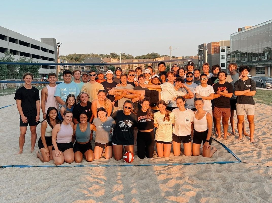 AXiD and PIKE members together after a sunset game of sand volleyball