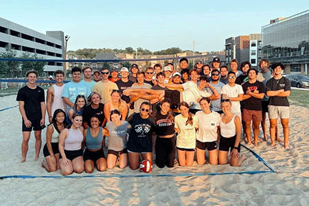 AXiD and PIKE members together after a sunset game of sand volleyball