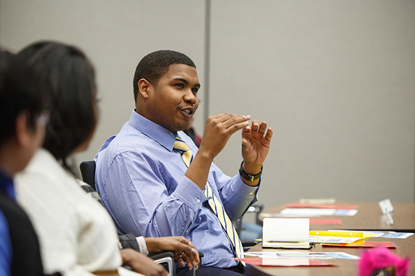 a student speaks at a student government meeting