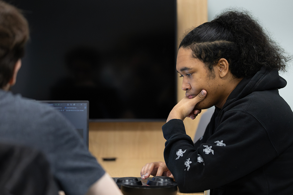 A student in a black hoodie looks thoughtfully off screen. The text reads "Understand Your Rights" with three red buttons for legal resources. The buttons are labeled "Know Your Rights," "Lease Agreement," and "Traffic Stops."