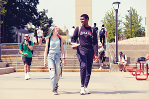 Two students walking outside on campus