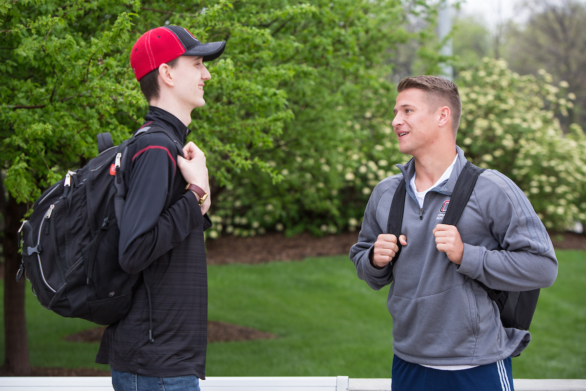 Two male students have a conversation
