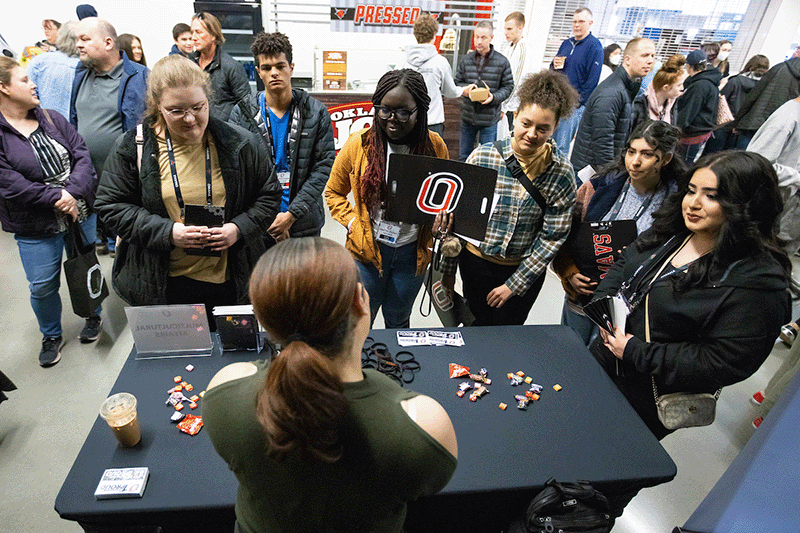 Students talk with a campus resource