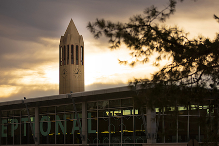 a view of criss library with the campanile in the background