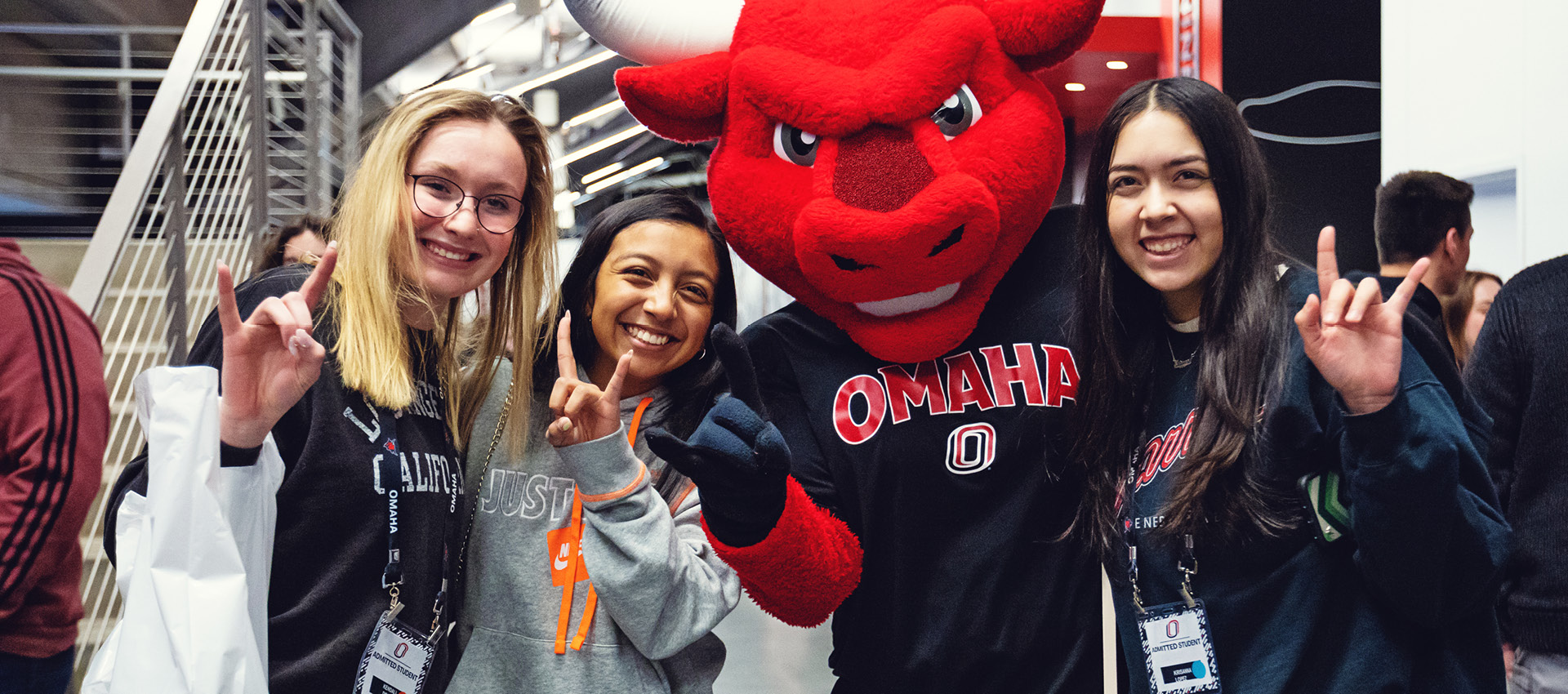Three new students post with Durango, the UNO mascot.