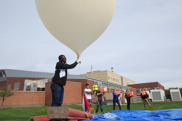 a uno professor conducts a physics experiment