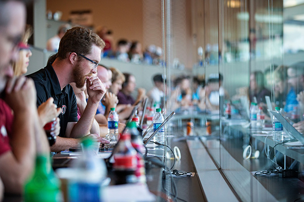 a row of reporters sits in the press box during the College World Series at TD Ameritrade Park in Omaha, Nebraska