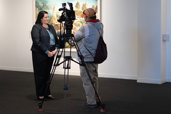 a woman is interviewed for a news story
