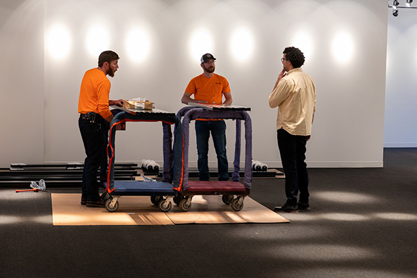 Workers install a storage rack and security system at the Samuel Bak Museum: The Learning Center