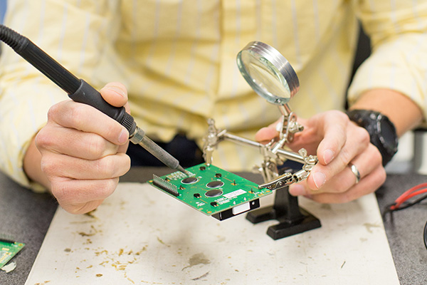 a person works with electrical engineering equipment