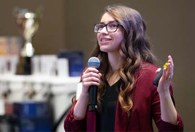 Female student holding a microphone