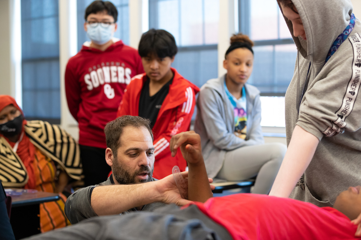 Dr. Adam Rosen demonstrates Athletic Training principles to students in a classroom