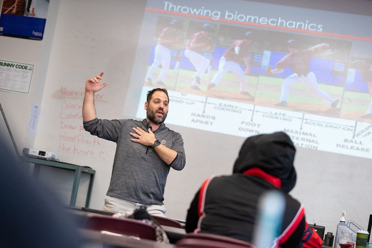 Dr. Adam Rosen demonstrates Athletic Training principles to students in a classroom
