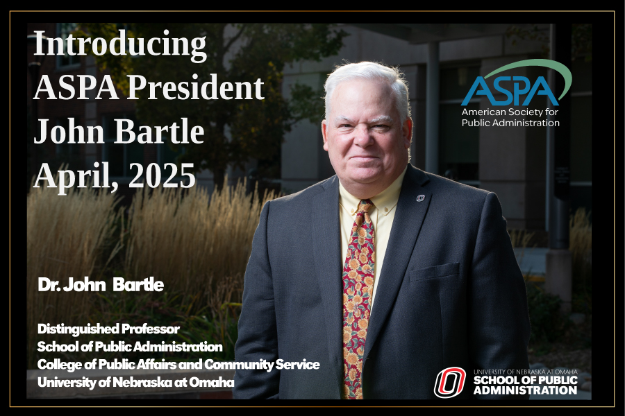 John Bartle standing with ASPA logo
