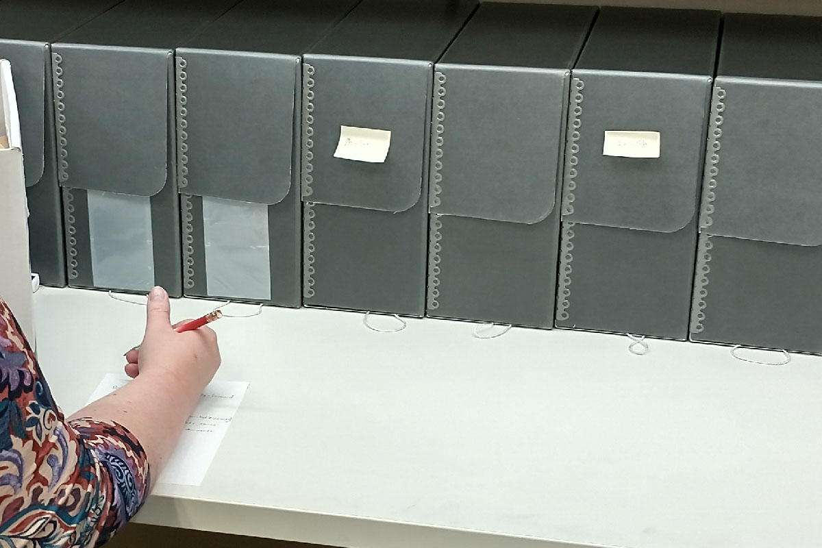 a table with a row of archival storage boxes on it 