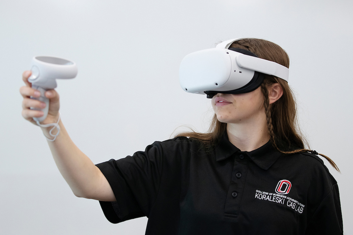 A student demos an Oculus virtual reality device, which has metaverse applications, in the Jack and Stephanie Koraleski Commerce and Applied Behavioral Laboratory.